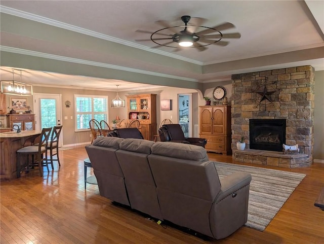 1445 Woodhaven Ln, Harrison, AR 72601 - living area with hardwood / wood-style flooring, a stone fireplace, ceiling fan, and crown molding