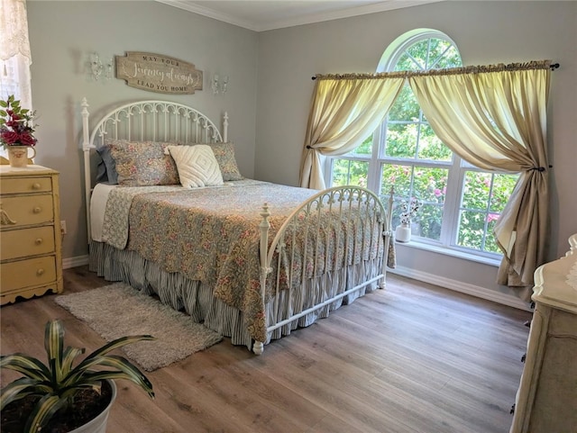 1445 Woodhaven Ln, Harrison, AR 72601 - bedroom with wood finished floors, ornamental molding, and multiple windows
