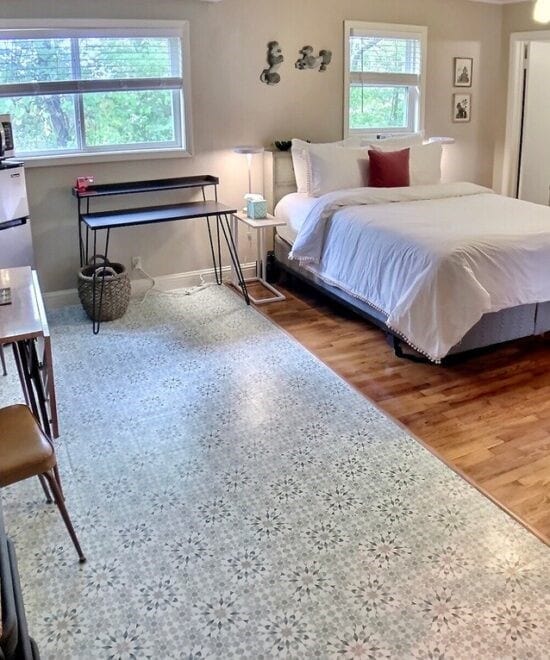 151 W Van Buren, Eureka Springs, AR 72632 - bedroom with wood finished floors and fridge