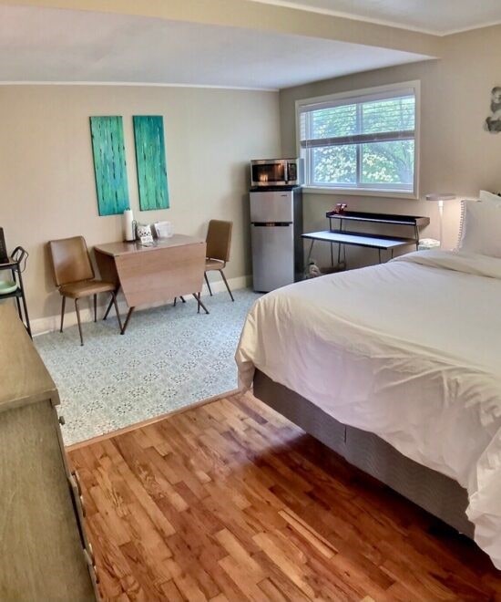 151 W Van Buren, Eureka Springs, AR 72632 - bedroom featuring fridge and wood finished floors