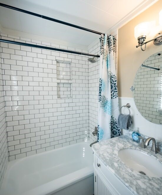 151 W Van Buren, Eureka Springs, AR 72632 - bathroom featuring shower / tub combo and vanity