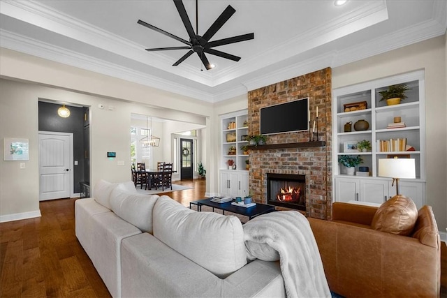 1200 Birkshire Cir, Cave Springs, AR 72718 - living area featuring ceiling fan, crown molding, dark wood-style floors, a raised ceiling, and a fireplace