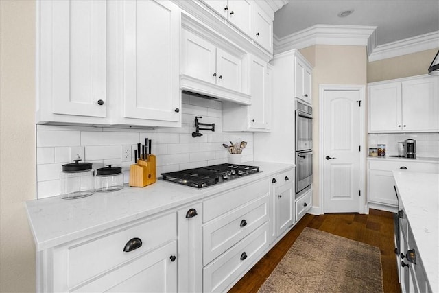 1200 Birkshire Cir, Cave Springs, AR 72718 - kitchen featuring appliances with stainless steel finishes, ornamental molding, tasteful backsplash, white cabinets, and dark wood-type flooring