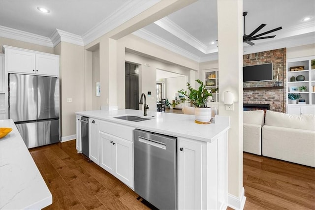 1200 Birkshire Cir, Cave Springs, AR 72718 - kitchen featuring stainless steel appliances, open floor plan, ceiling fan, ornamental molding, and a brick fireplace