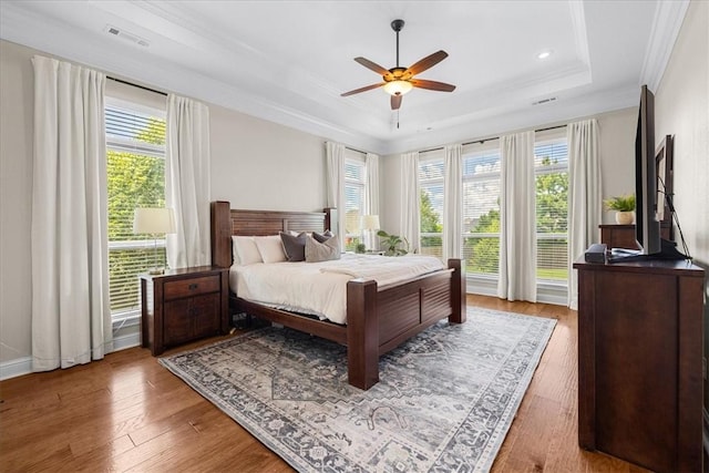 1200 Birkshire Cir, Cave Springs, AR 72718 - bedroom with a raised ceiling, multiple windows, wood finished floors, ornamental molding, and recessed lighting