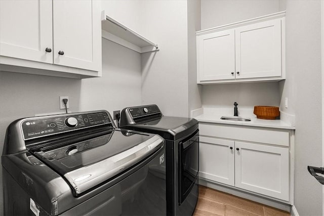 1200 Birkshire Cir, Cave Springs, AR 72718 - washroom with washer and dryer, cabinet space, and light wood-style flooring