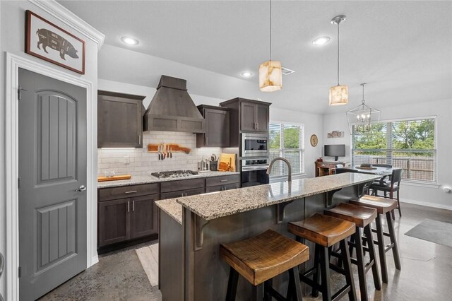 4278 W Anthem Dr, Fayetteville, AR 72704 - kitchen with premium range hood, appliances with stainless steel finishes, tasteful backsplash, dark brown cabinetry, and recessed lighting
