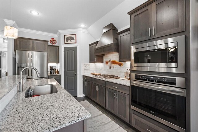 4278 W Anthem Dr, Fayetteville, AR 72704 - kitchen featuring stainless steel appliances, custom exhaust hood, dark brown cabinetry, crown molding, and light stone countertops