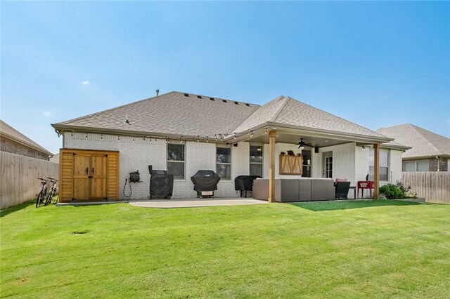 4278 W Anthem Dr, Fayetteville, AR 72704 - back of property with a ceiling fan, a patio, brick siding, and a fenced backyard