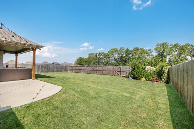 4278 W Anthem Dr, Fayetteville, AR 72704 - fenced backyard with a patio area