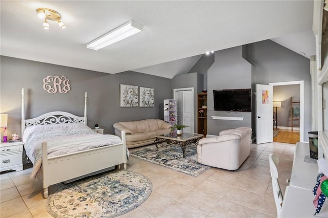 1112 N Oriole Ave, Rogers, AR 72756 - bedroom featuring light tile patterned flooring, lofted ceiling, and a closet