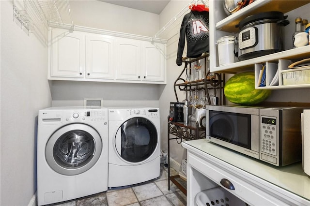 1112 N Oriole Ave, Rogers, AR 72756 - washroom with washer and clothes dryer, cabinet space, and light stone finish floors
