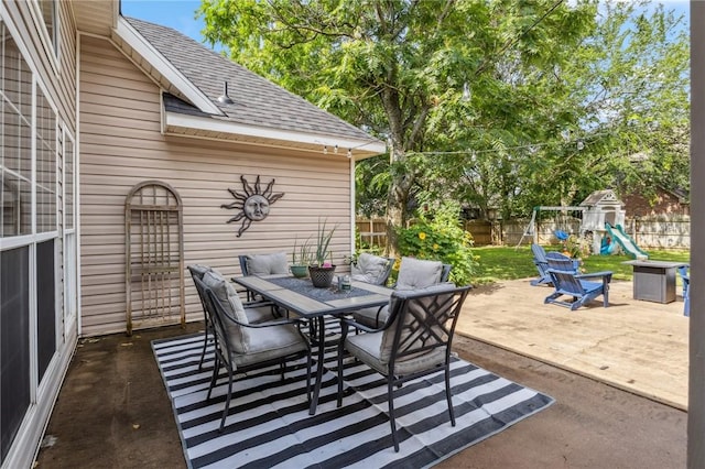 1112 N Oriole Ave, Rogers, AR 72756 - fenced backyard with outdoor dining space, a playground, and a wooden deck
