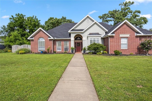 1112 N Oriole Ave, Rogers, AR 72756 - traditional home featuring brick siding, a shingled roof, and stucco siding
