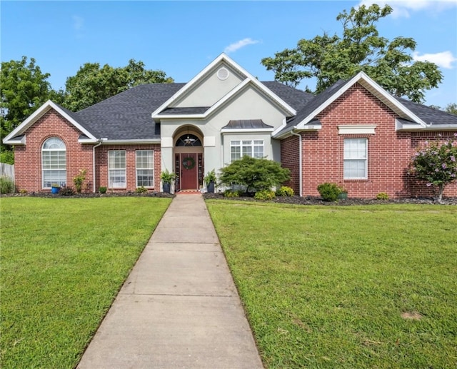 1112 N Oriole Ave, Rogers, AR 72756 - traditional-style house with brick siding, a front lawn, a shingled roof, and stucco siding