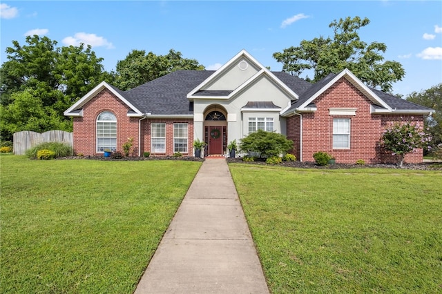 1112 N Oriole Ave, Rogers, AR 72756 - traditional-style home featuring brick siding, a shingled roof, and stucco siding