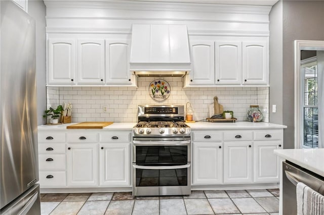 1112 N Oriole Ave, Rogers, AR 72756 - kitchen featuring stainless steel appliances, custom range hood, light countertops, ornamental molding, and white cabinetry
