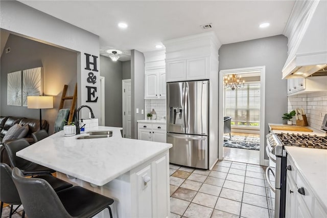 1112 N Oriole Ave, Rogers, AR 72756 - kitchen featuring appliances with stainless steel finishes, custom range hood, tasteful backsplash, light countertops, and white cabinetry