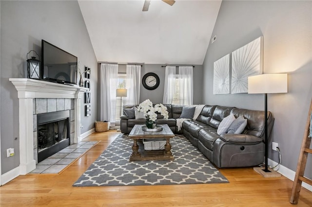 1112 N Oriole Ave, Rogers, AR 72756 - living area with a ceiling fan, a fireplace, wood finished floors, and high vaulted ceiling