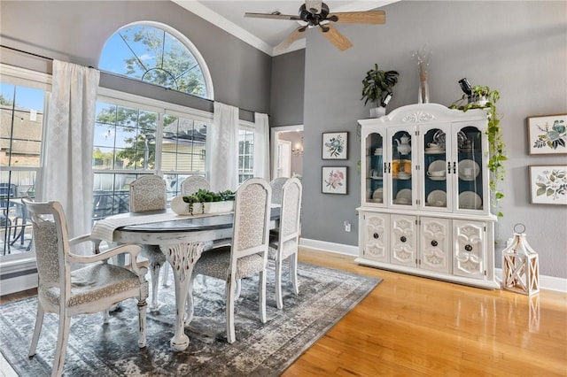 1112 N Oriole Ave, Rogers, AR 72756 - dining area featuring light wood-type flooring, a ceiling fan, crown molding, and high vaulted ceiling