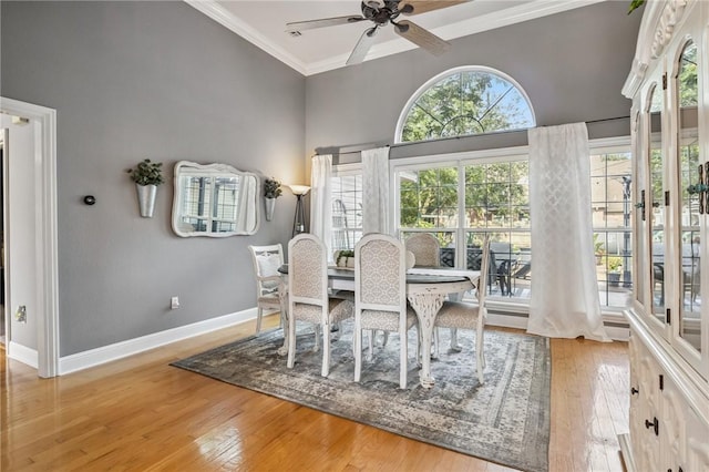 1112 N Oriole Ave, Rogers, AR 72756 - dining area with wood-type flooring, a ceiling fan, and crown molding