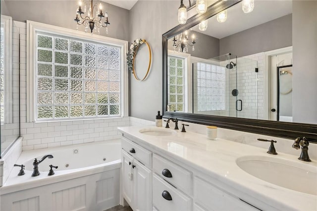 1112 N Oriole Ave, Rogers, AR 72756 - bathroom featuring a chandelier, a tub with jets, a stall shower, and healthy amount of natural light