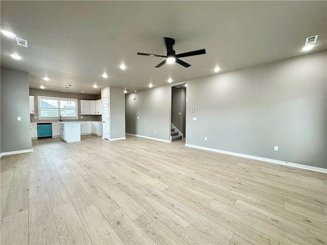 6003 SW Desert Ave, Bentonville, AR 72713 - unfurnished living room with a ceiling fan, light wood finished floors, stairs, and recessed lighting