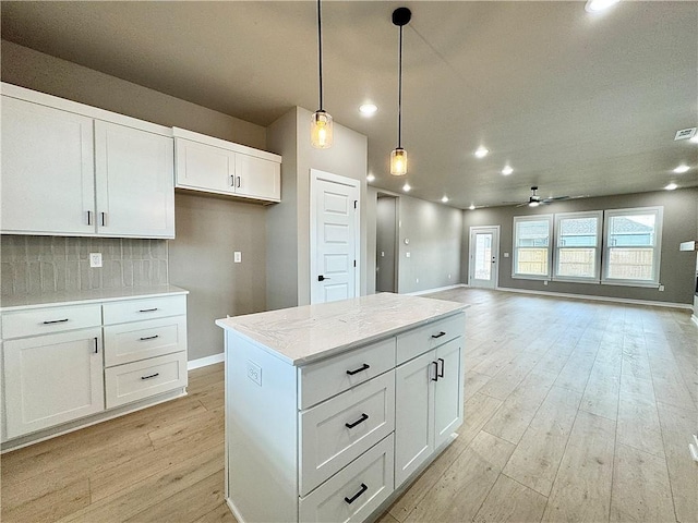 6003 SW Desert Ave, Bentonville, AR 72713 - kitchen with ceiling fan, light wood-style floors, tasteful backsplash, white cabinetry, and recessed lighting