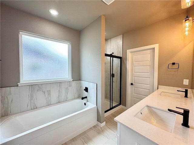 6003 SW Desert Ave, Bentonville, AR 72713 - bathroom with a garden tub, a stall shower, double vanity, marble look tiles, and recessed lighting