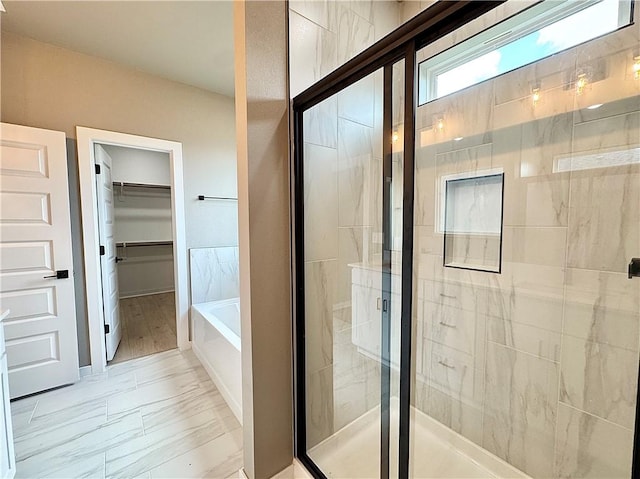 6003 SW Desert Ave, Bentonville, AR 72713 - full bathroom with a stall shower, a garden tub, and a walk in closet