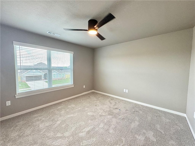 6003 SW Desert Ave, Bentonville, AR 72713 - unfurnished room with a ceiling fan, carpet flooring, and a textured ceiling