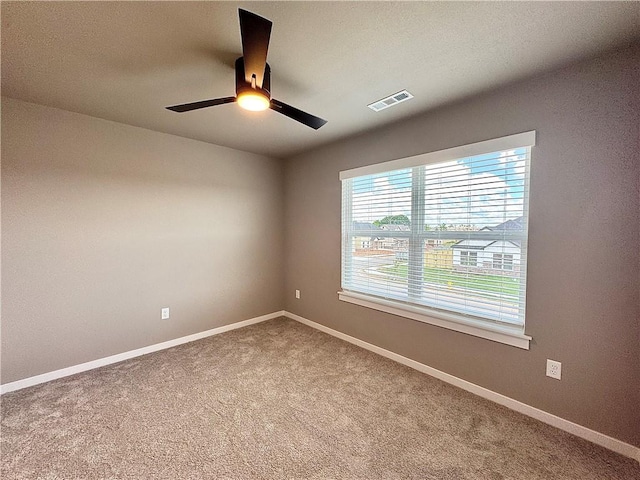6003 SW Desert Ave, Bentonville, AR 72713 - carpeted spare room featuring a ceiling fan and baseboards