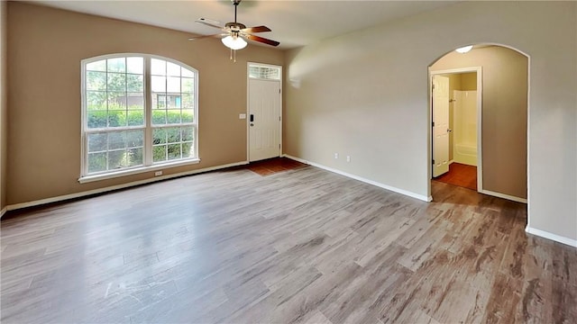 3107 SW Wentworth Ave, Bentonville, AR 72713 - spare room featuring a ceiling fan, arched walkways, and wood finished floors