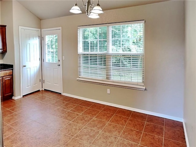3107 SW Wentworth Ave, Bentonville, AR 72713 - unfurnished dining area featuring light tile patterned flooring, a chandelier, and vaulted ceiling