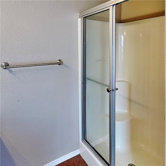 3107 SW Wentworth Ave, Bentonville, AR 72713 - bathroom featuring a stall shower and a textured wall