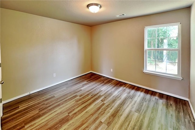 3107 SW Wentworth Ave, Bentonville, AR 72713 - unfurnished room featuring healthy amount of natural light and wood finished floors