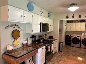 411 Natchez Trace St, Harrison, AR 72601 - kitchen with appliances with stainless steel finishes, washer and dryer, white cabinetry, and dark countertops