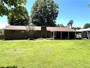 411 Natchez Trace St, Harrison, AR 72601 - back of house featuring a lawn