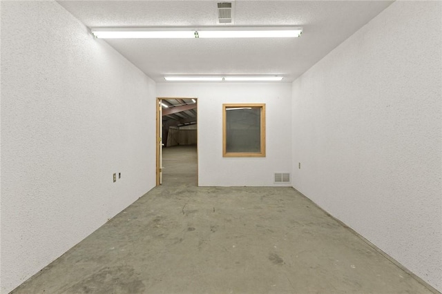 12158 E 62nd Hwy, Harrison, AR 72601 - empty room with concrete floors and a textured wall