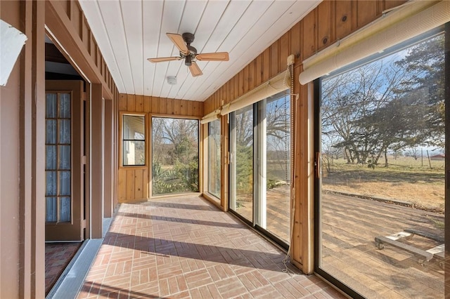 12158 E 62nd Hwy, Harrison, AR 72601 - unfurnished sunroom with brick patterned flooring and wood walls