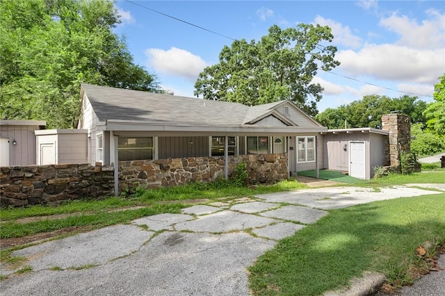 702 E Argyle, Harrison, AR 72601 - ranch-style home featuring stone siding, roof with shingles, and a chimney