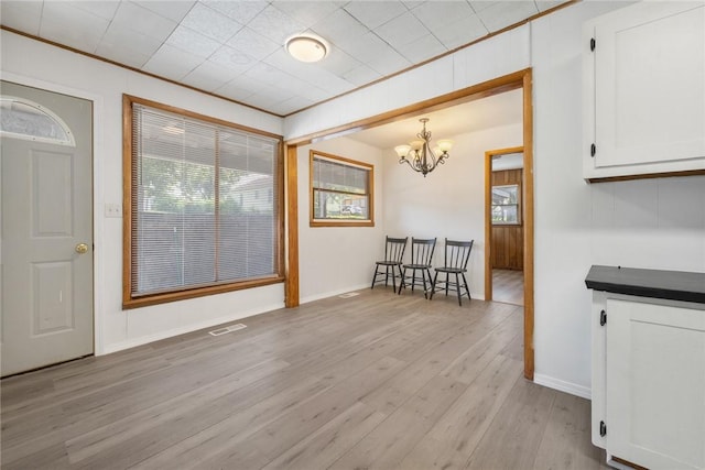 702 E Argyle, Harrison, AR 72601 - dining space with a chandelier, light wood-style floors, and ornamental molding