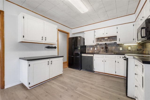 702 E Argyle, Harrison, AR 72601 - kitchen featuring black appliances, dark countertops, and white cabinets