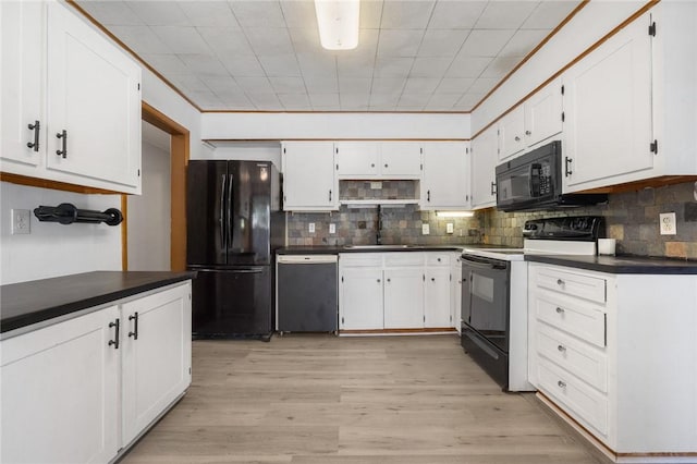 702 E Argyle, Harrison, AR 72601 - kitchen featuring black appliances, dark countertops, decorative backsplash, and white cabinets