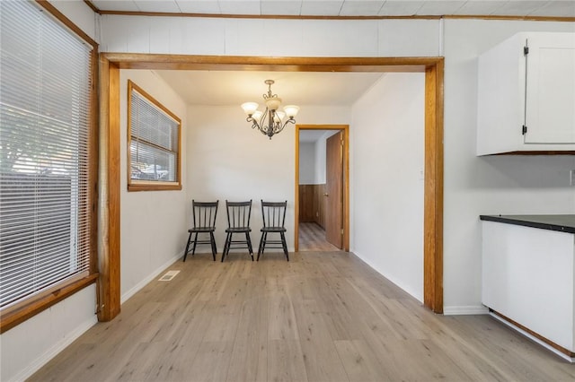 702 E Argyle, Harrison, AR 72601 - dining space with light wood finished floors and a chandelier