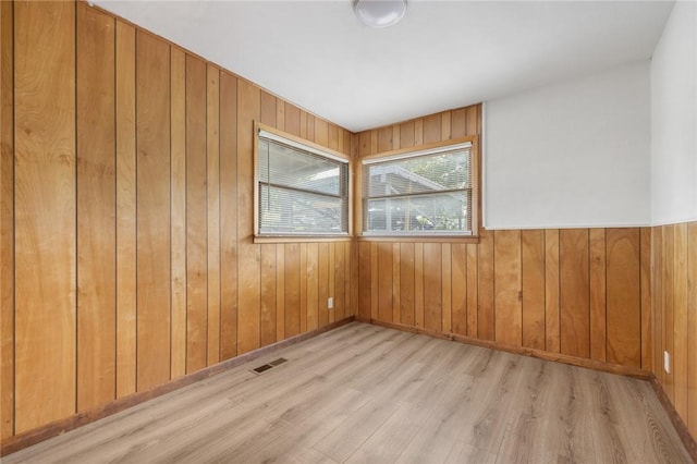 702 E Argyle, Harrison, AR 72601 - spare room with wood finished floors and wooden walls