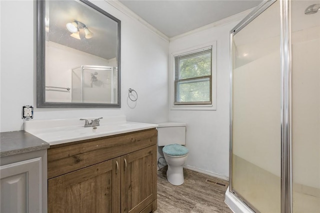 702 E Argyle, Harrison, AR 72601 - bathroom with crown molding, vanity, a shower stall, and wood finished floors