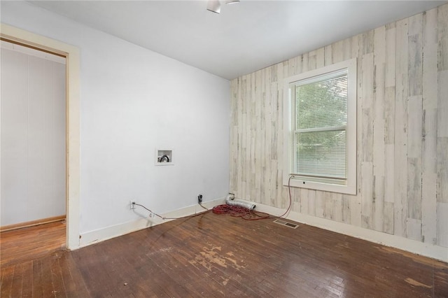 702 E Argyle, Harrison, AR 72601 - empty room with wood-type flooring and wood walls