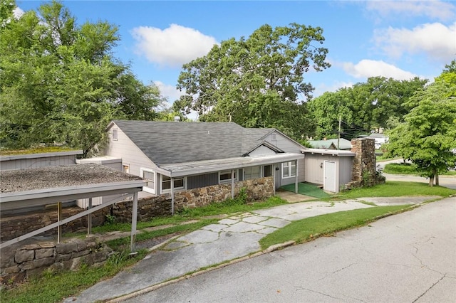702 E Argyle, Harrison, AR 72601 - view of front facade featuring stone siding, covered porch, and roof with shingles