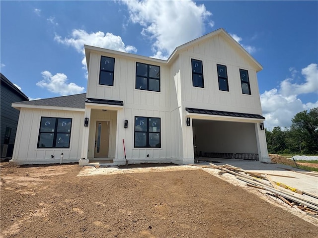 4116 Erin Dr, Rogers, AR 72758 - modern farmhouse featuring driveway, a garage, board and batten siding, a standing seam roof, and a metal roof